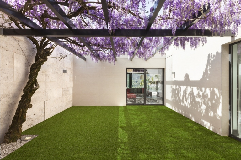 A house with a courtyard covered in artificial turf